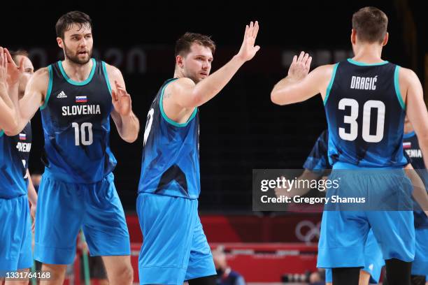 Mike Tobey, Luka Doncic, and Zoran Dragic of Team Slovenia celebrate after defeating Spain in a Men's Basketball Preliminary Round Group C game at...