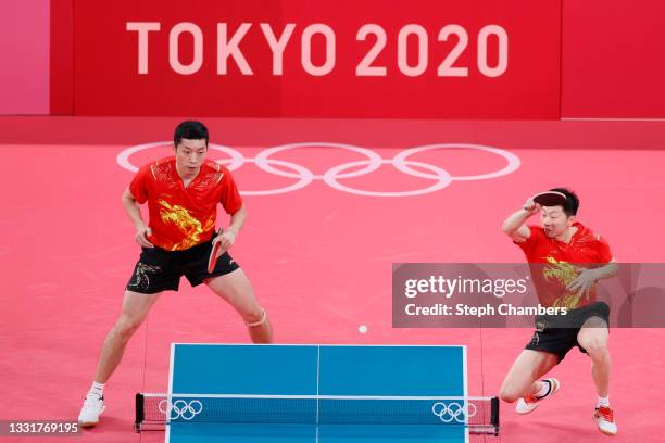 Xu Xin and Ma Long of Team China in action during their Men's Team Round of 16 table tennis match on day nine of the Tokyo 2020 Olympic Games at...