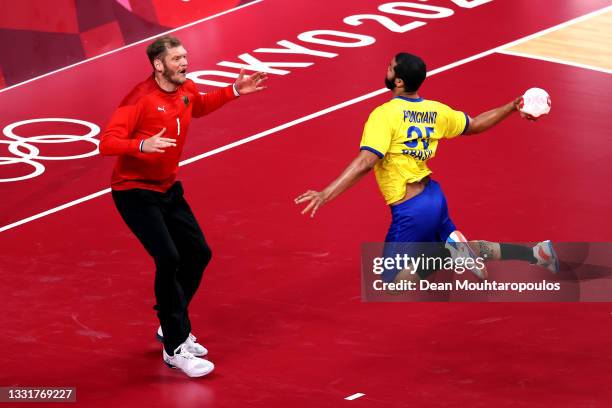Johannes Bitter of Team Germany saves a shot on goal from Thiago Ponciano of Team Brazil during the Men's Preliminary Round Group A handball match...