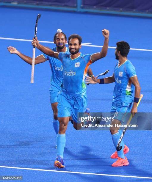 Gurjant Singh of Team India celebrates with teammates Hardik Singh and Shamsher Singh after scoring their team's second goal during the Men's...