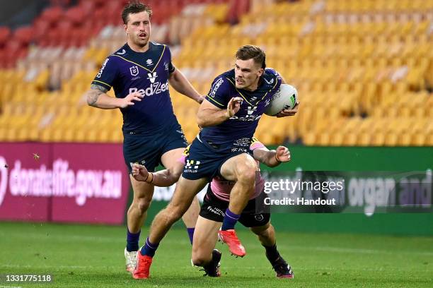 In this handout image provided by NRL Photos Ryan Papenhuyzen of the Storm makes a break during the round 20 NRL match between the Melbourne Storm...