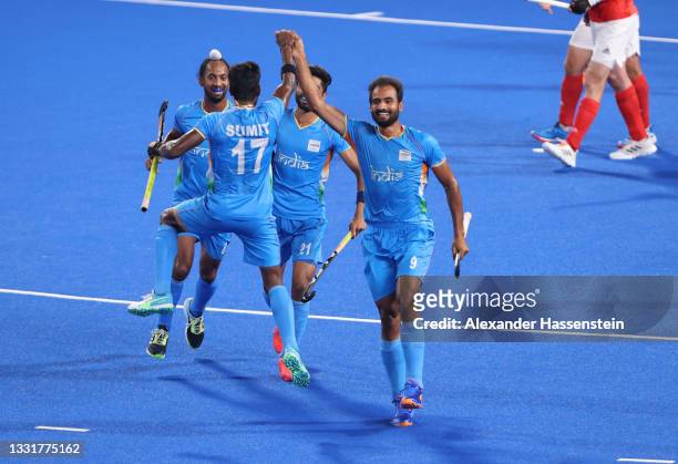 Gurjant Singh of Team India celebrates with teammates Sumit, Hardik Singh and Shamsher Singh after scoring their team's second goal during the Men's...
