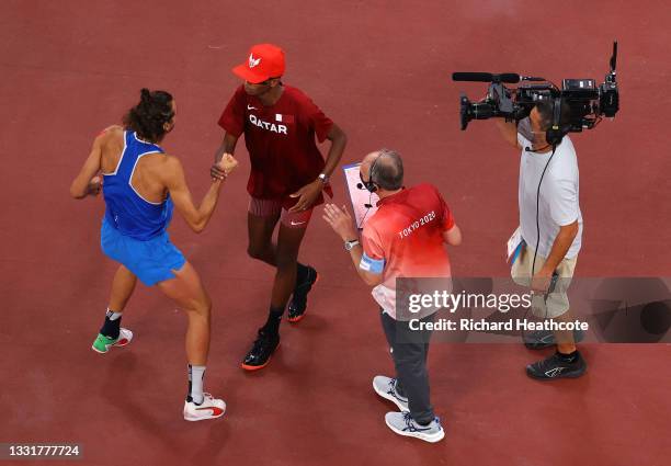 Gianmarco Tamberi of Team Italy and Mutaz Essa Barshim of Team Qatar react after winning the gold medal in the men's High Jump on day nine of the...