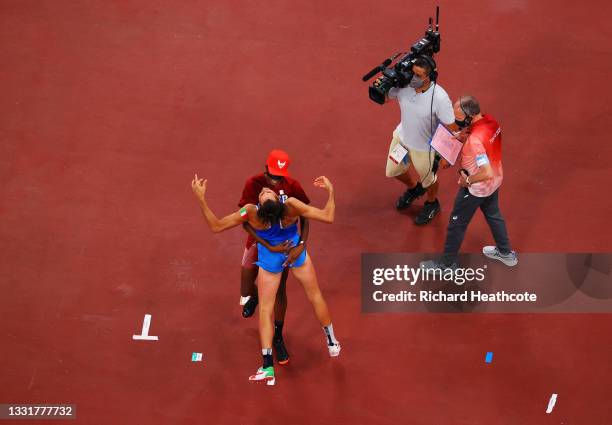 Gianmarco Tamberi of Team Italy and Mutaz Essa Barshim of Team Qatar react after winning the gold medal in the men's High Jump on day nine of the...