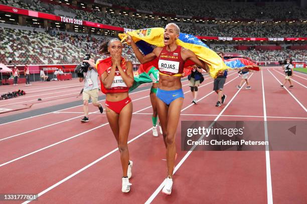 Bronze medalist Ana Peleteiro of Team Spain and gold medalist Yulimar Rojas of Team Venezuela celebrate on the track following the Women's Triple...