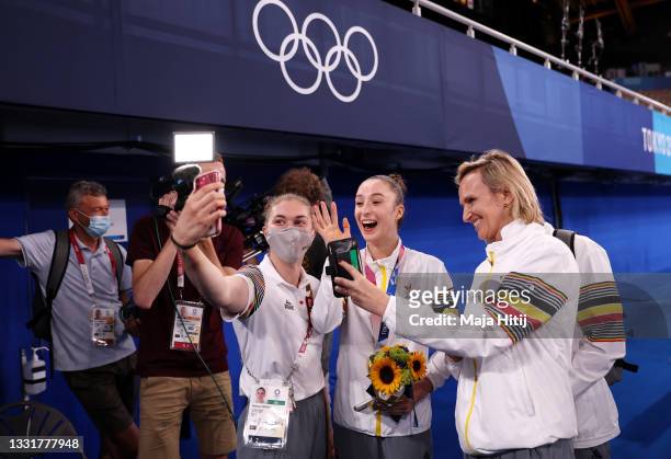 Gold medalist Nina Derwael of Team Belgium celebrates with teammates following the Women's Uneven Bars Final on day nine of the Tokyo 2020 Olympic...