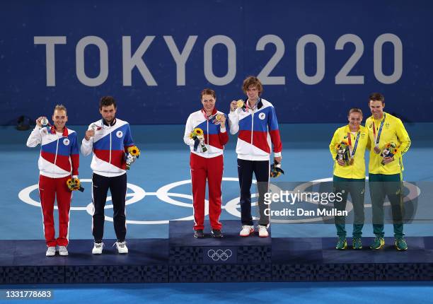 Silver medalists Elena Vesnina of Team ROC and Aslan Karatsev of Team ROC, gold medalists Anastasia Pavlyuchenkova of Team ROC and Andrey Rublev of...