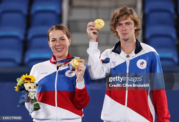 Gold medalists Anastasia Pavlyuchenkova of Team ROC and Andrey Rublev of Team ROC pose on the podium during the medal ceremony for Tennis Mixed...