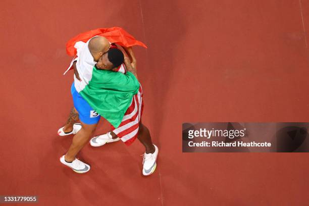 Lamont Marcell Jacobs of Team Italy and Fred Kerley of Team United States embrace after completing the Men's 100m Final on day nine of the Tokyo 2020...