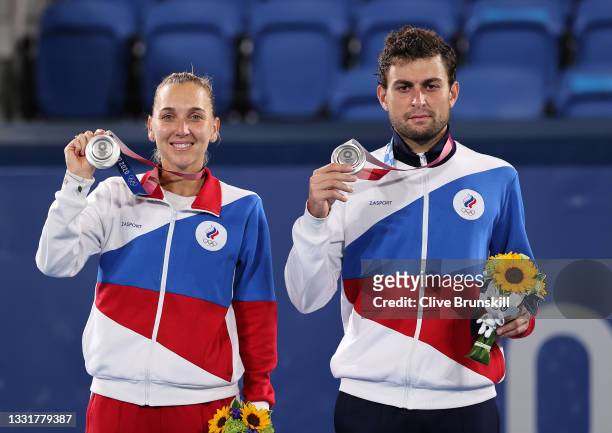 Silver medalists Elena Vesnina of Team ROC and Aslan Karatsev of Team ROC pose on the podium during the medal ceremony for Tennis Mixed Doubles on...