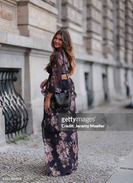 Farina Opoku wearing a long floral dress and black Prada bag on July 29, 2021 in Berlin, Germany.