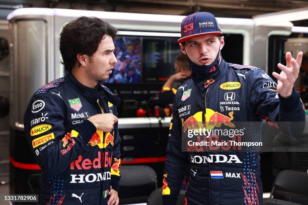 Max Verstappen of Netherlands and Red Bull Racing and Sergio Perez of Mexico and Red Bull Racing talk in the garage during the red flag delay during...