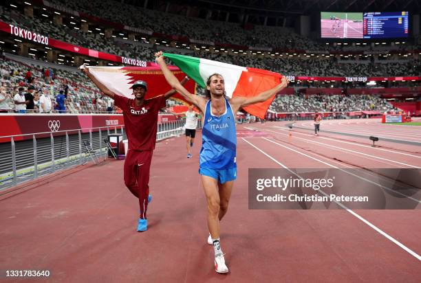 Gold medalist Mutaz Essa Barshim of Team Qatar and silver medalist Gianmarco Tamberi of Team Italy celebrate on the track following the Men's High...