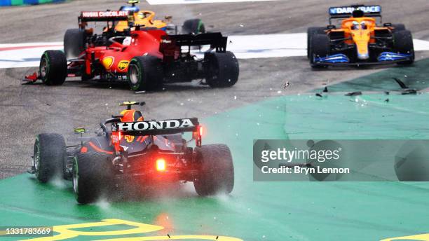 Sergio Perez of Mexico driving the Red Bull Racing RB16B Honda runs wide at the start as cars tangle ahead of him during the F1 Grand Prix of Hungary...