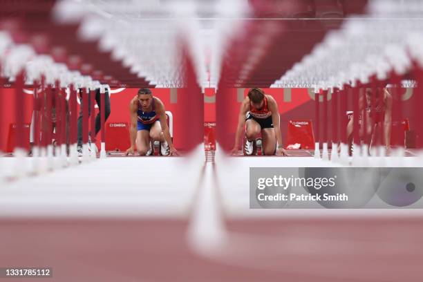 Andrea Carolina Vargas of Team Costa Rica and Asuka Terada of Team Japan prepare to compete in the Women's 100m Hurdles Semi-Final on day nine of the...