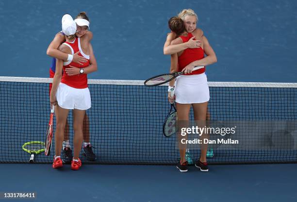 Belinda Bencic of Team Switzerland and Viktorija Golubic of Team Switzerland congratulate Barbora Krejcikova of Team Czech Republic and Katerina...