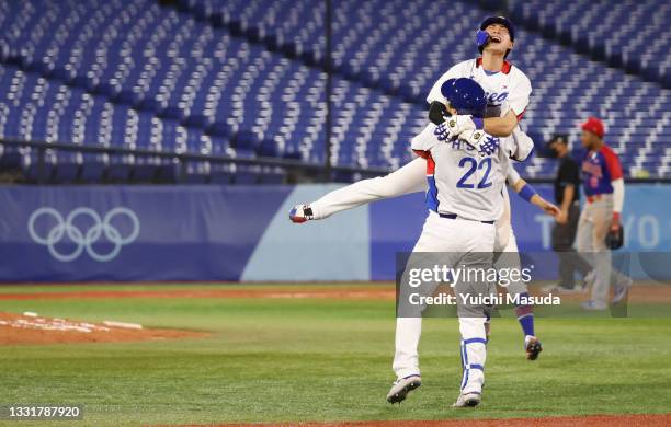 Hyunsoo Kim of Team South Korea celebrates with Jung Hoo Lee after hitting an RBI single in the ninth inning to win the game during the round one of...