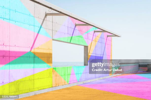 colorful art work in minimal architecture concrete with sea window. - architecture and art fotografías e imágenes de stock