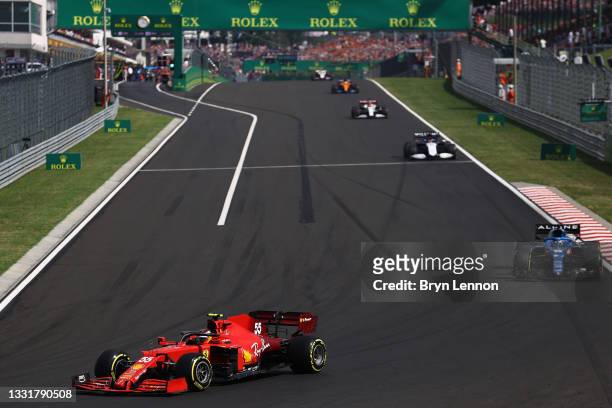 Carlos Sainz of Spain driving the Scuderia Ferrari SF21 leads Fernando Alonso of Spain driving the Alpine A521 Renault during the F1 Grand Prix of...