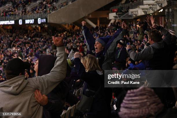 Fremantle fans celebrate winning the round 20 AFL match between Fremantle Dockers and Richmond Tigers at Optus Stadium on August 01, 2021 in Perth,...