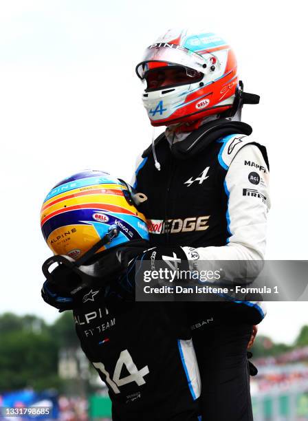 Race winner Esteban Ocon of France and Alpine F1 Team and fifth placed Fernando Alonso of Spain and Alpine F1 Team celebrate in parc ferme during the...