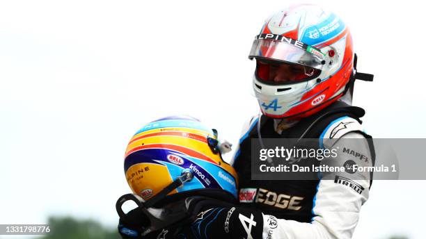 Race winner Esteban Ocon of France and Alpine F1 Team and fifth placed Fernando Alonso of Spain and Alpine F1 Team celebrate in parc ferme during the...