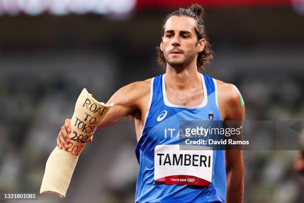 Gold medalist Gianmarco Tamberi of Team Italy holds a shell of an old cast inscribed 'Road to Tokyo 2020, 2021' during the Men's High Jump Final on...