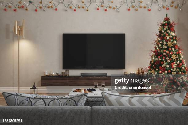 living room interior with christmas tree, ornaments, gift boxes, red sofa and lcd tv set - living room tv stock pictures, royalty-free photos & images