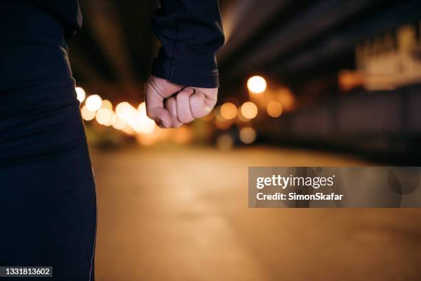 hand of man with clenched fist - threats stockfoto's en -beelden