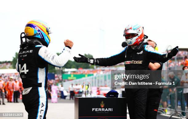 Race winner Esteban Ocon of France and Alpine F1 Team and fifth placed Fernando Alonso of Spain and Alpine F1 Team celebrate in parc ferme during the...