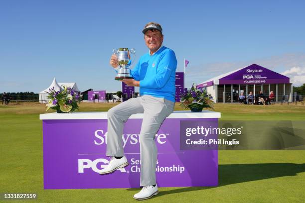 Paul Broadhurst of England poses with the trophy and official suppliers after the final round of the Staysure PGA Championship at Formby Golf Club on...