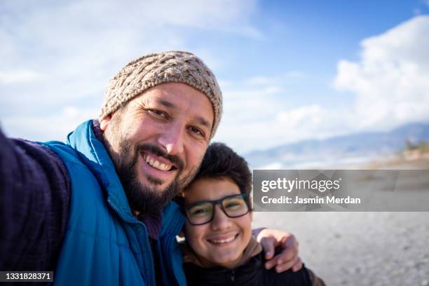 father and son on winter coast - beach selfie bildbanksfoton och bilder