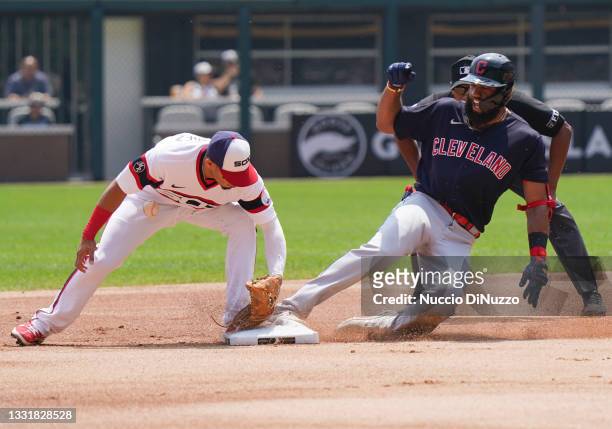 Amed Rosario of the Cleveland Indians slides into second base against Cesar Hernandez of the Chicago White Sox after his double during the first...