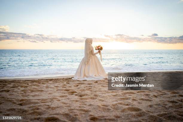 alone muslim bride with hijab on beach - arabic wedding stock pictures, royalty-free photos & images