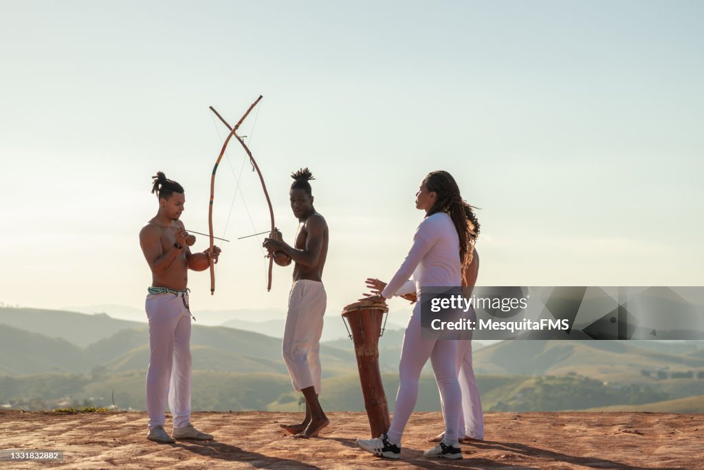 Capoeira people playing berimbau and percussion instruments