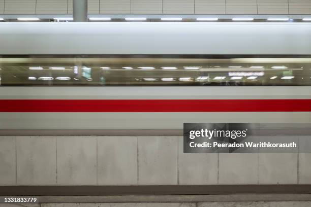 horizontal view of platform railway train station and motion of ice high speed train. - railway bridge stock-fotos und bilder