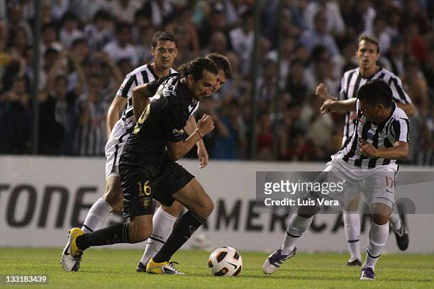 Hernan Barcos, from Liga Universitaria de Quito, fights for the ball with William Mendieta, from Libertad, during a match between Liga Universitaria...