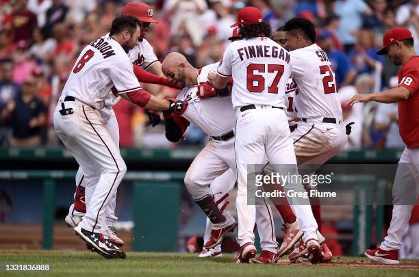 Yadiel Hernandez of the Washington Nationals celebrates with teammates after hitting a walk-off home run in the ninth inning against the Chicago Cubs...
