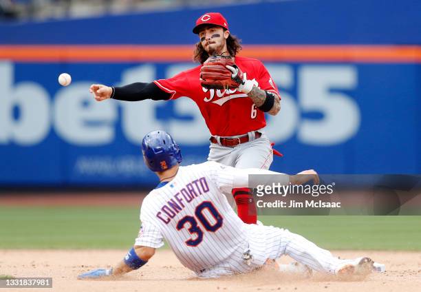 Jonathan India of the Cincinnati Reds completes a seventh inning double play after forcing out Michael Conforto of the New York Mets at Citi Field on...