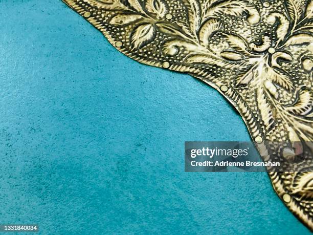 blue surface with gold leaf embellishment - indian culture background stock pictures, royalty-free photos & images
