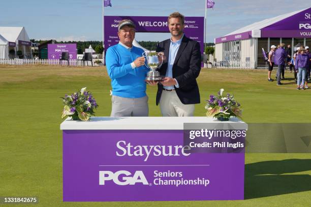 Paul Broadhurst of England poses with Mark Aspland, Head of the Legends Tour after the final round of the Staysure PGA Championship at Formby Golf...