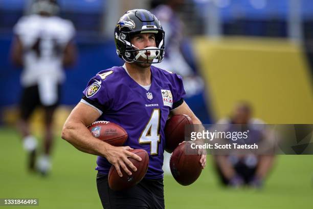 Sam Koch of the Baltimore Ravens carries footballs during training camp at M&T Bank Stadium on July 31, 2021 in Baltimore, Maryland.