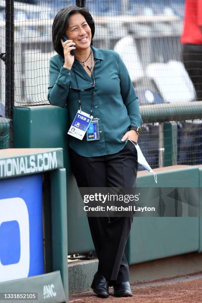 General manager Kim Ng of the Miami Marlins on the phone during batting practice of a baseball game against the Washington Nationals at National Park...