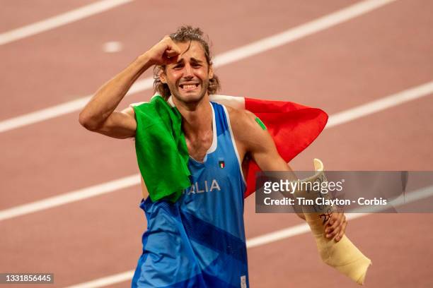 August 1: An emotional Gianmarco Tamberi of Italy reacts after winning the gold medley jointly with Mutaz Essa Barshim of Qatar in the high jump for...
