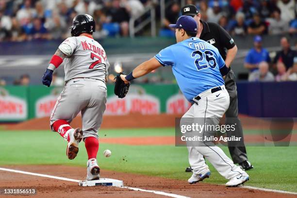 Christian Vazquez of the Boston Red Sox arrives safe at first on a passed ball by Mike Zunino of the Tampa Bay Rays in the second inning at Tropicana...