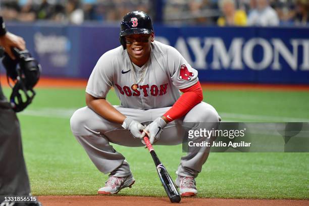 Rafael Devers of the Boston Red Sox reacts after being hit by a foul ball in the first inning against the Tampa Bay Rays at Tropicana Field on August...