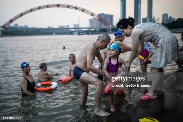 Residents swim in the Han River on August 1, 2021 in Wuhan, Hubei Province, China. The local meteorological bureau issued a high temperature warning...