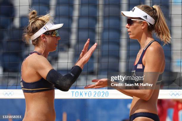 April Ross of Team United States celebrates with Alix Klineman after the play against Team Cuba during the Women's Round of 16 beach volleyball on...