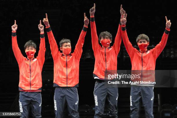 Gold medalists Koki Kano, Kazuyasu Minobe, Satoru Uyama and Masaru Yamada of Team Japan pose on the podium at the medal ceremony for the Men's Epee...
