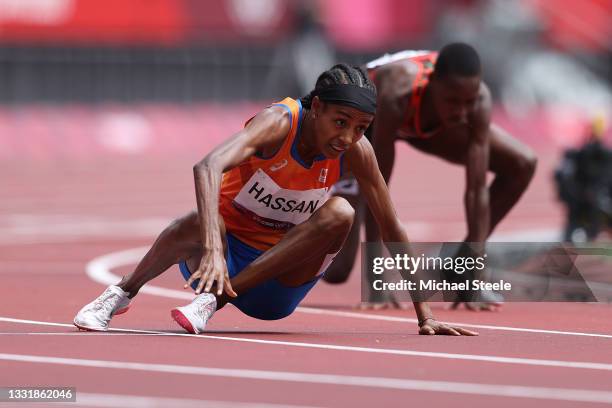 Sifan Hassan of Team Netherlands gets back up after falling over Edinah Jebitok of Team Kenya in round one of the Women's 1500m heats on day ten of...